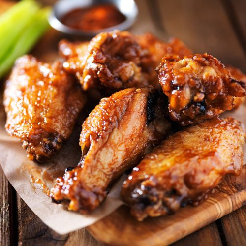 chicken wings on wooden tray